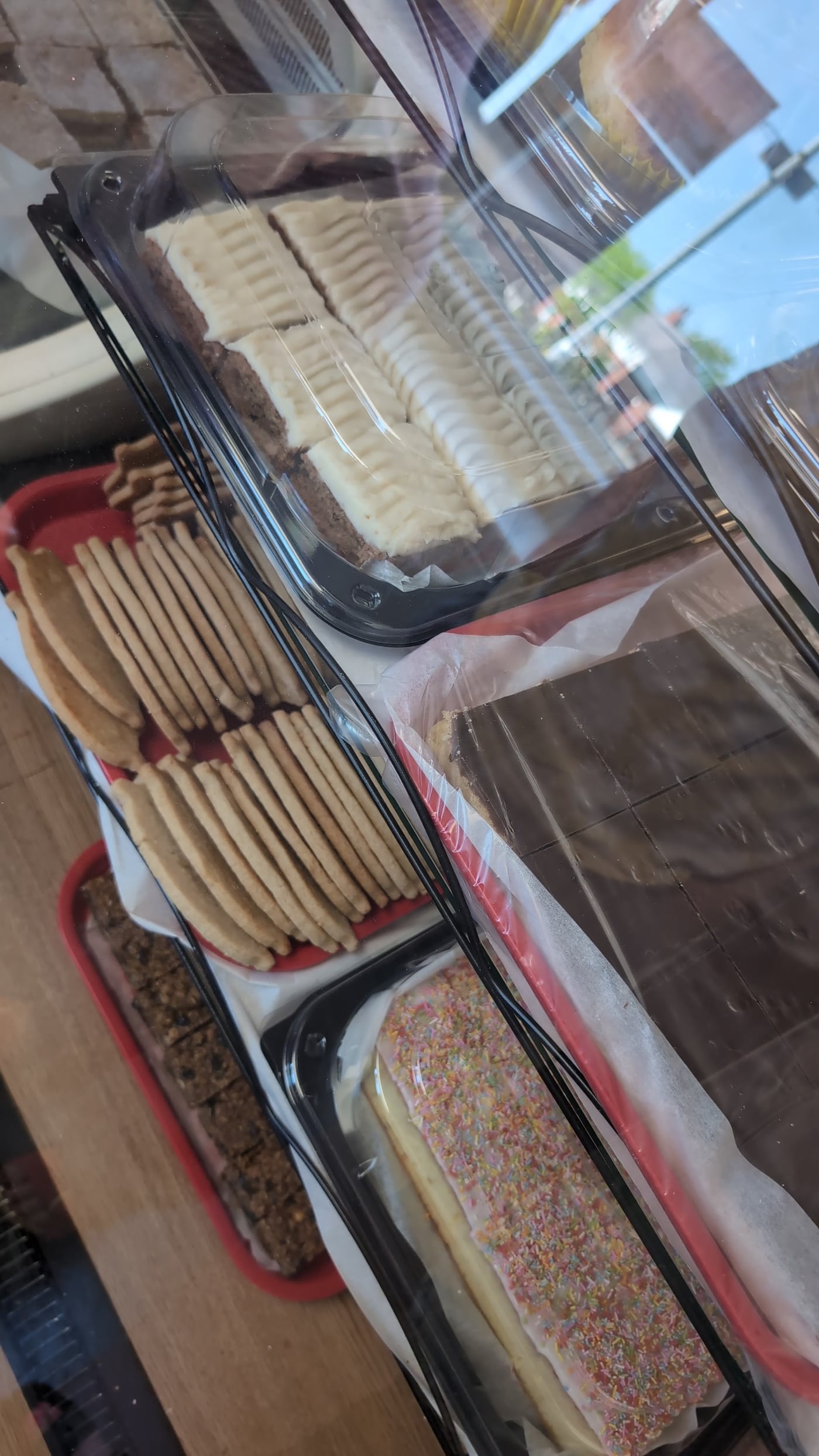 Rows of cakes and biscuits in the Moores bakery counter